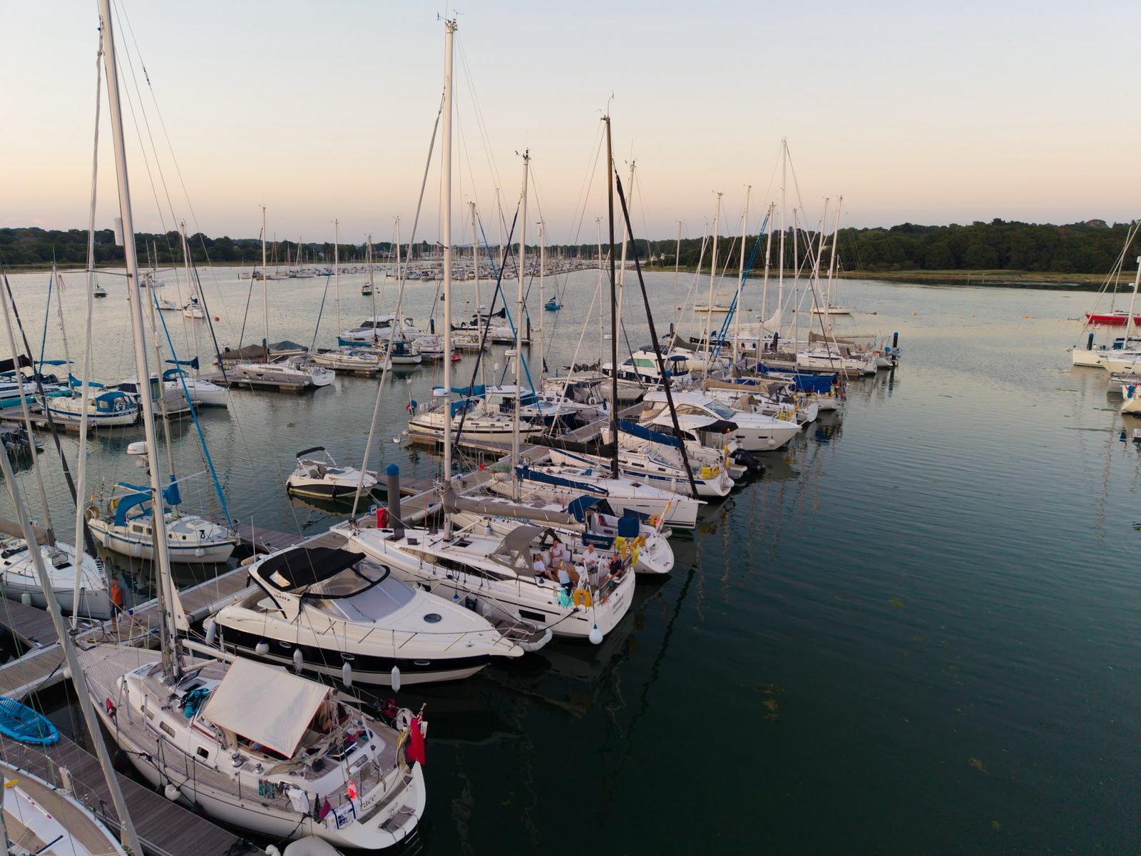 Yachts on the pontoons at Mercury Yacht Harbour at dusk, looking down the River Hamble